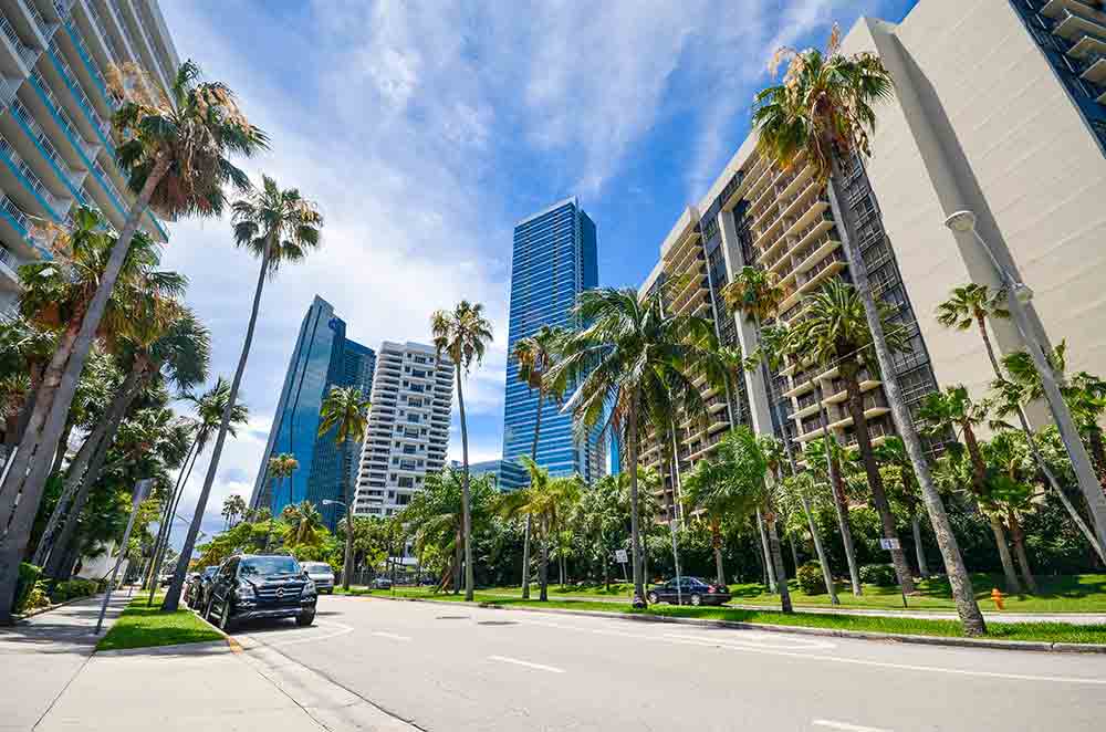 Image is to the right side of text and is of a downtown Florida skyscraper view looking up.