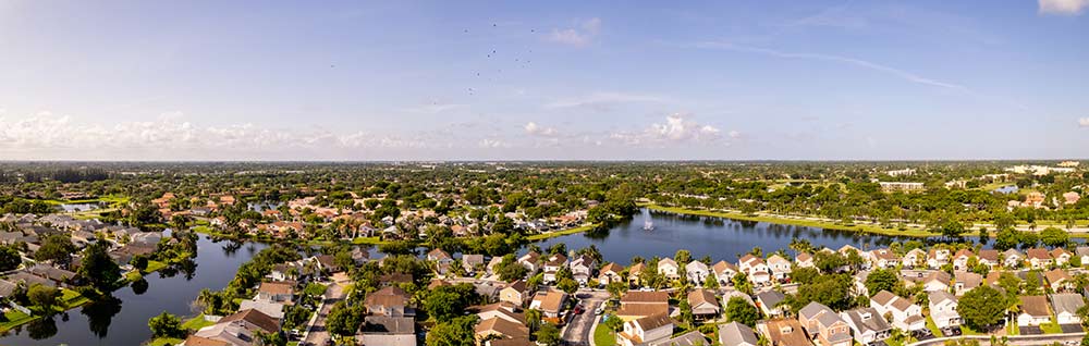 Bottom image is a panoramic aerial view of Sunrise Florida neighborhoods and waterways. 